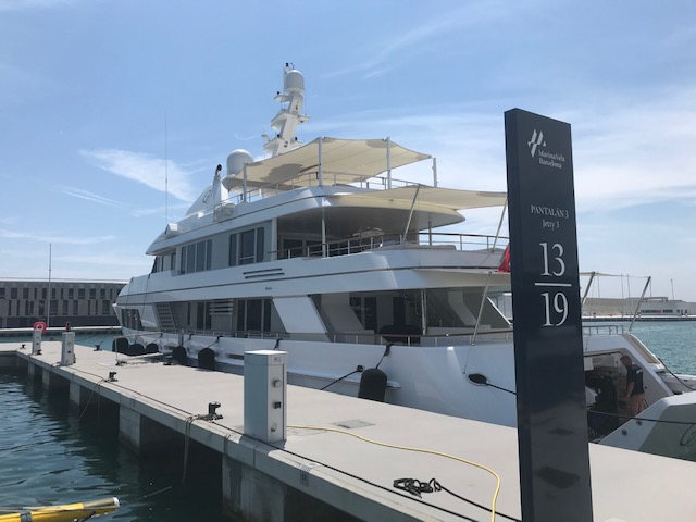 Large white yacht moored at Pantalan 3, berth 13-19 in a modern marina.