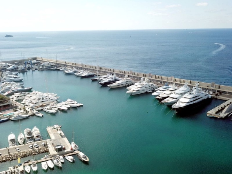 Aerial view of luxury yachts docked at the mooring berths in Port Adriano, Mallorca, Spain.