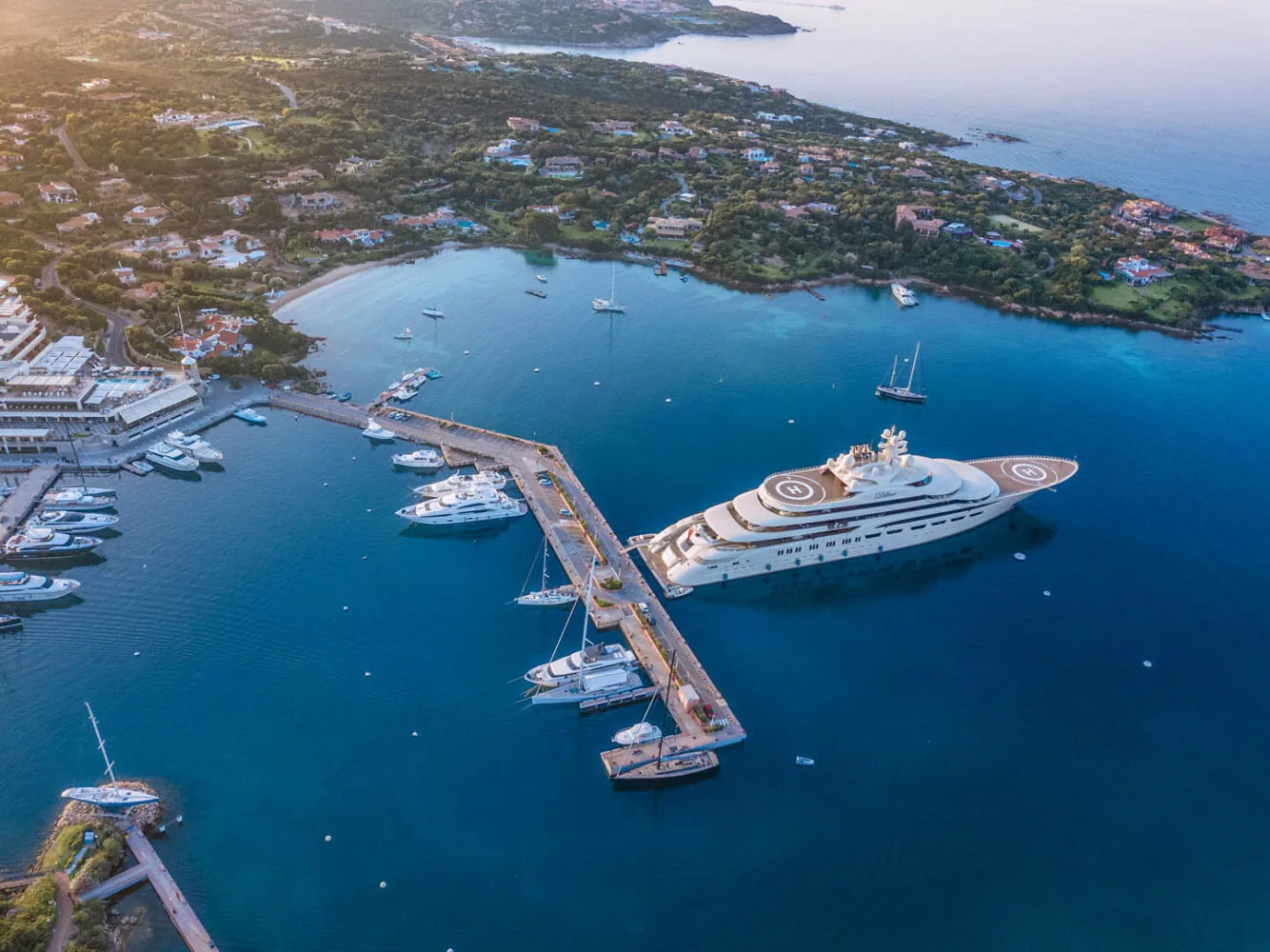 Aerial view of luxury yachts docked at Porto Cervo Marina on the coast of Sardinia.