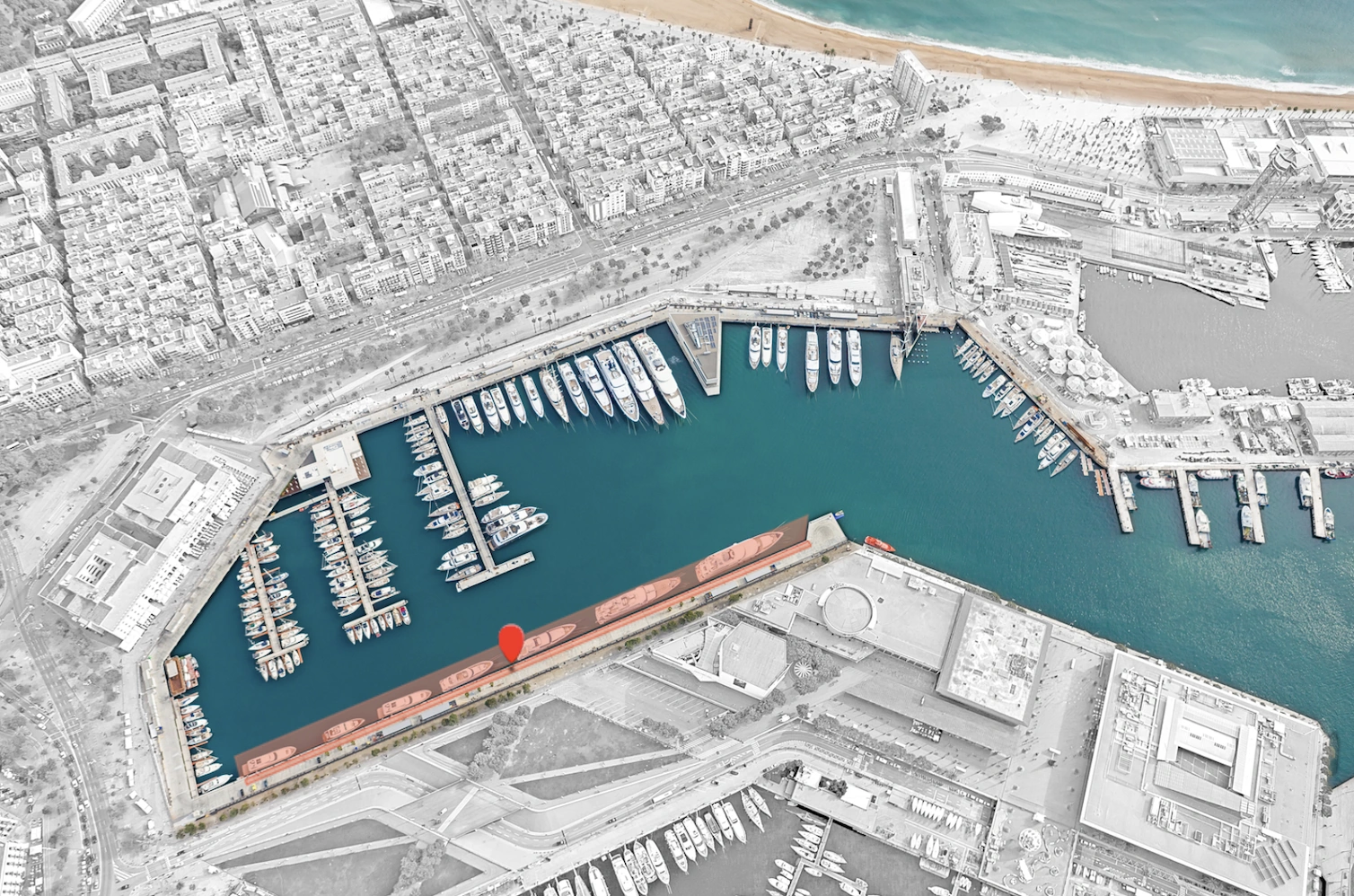 Aerial view of Marina Port Vell in Barcelona with numerous yachts docked along the piers.