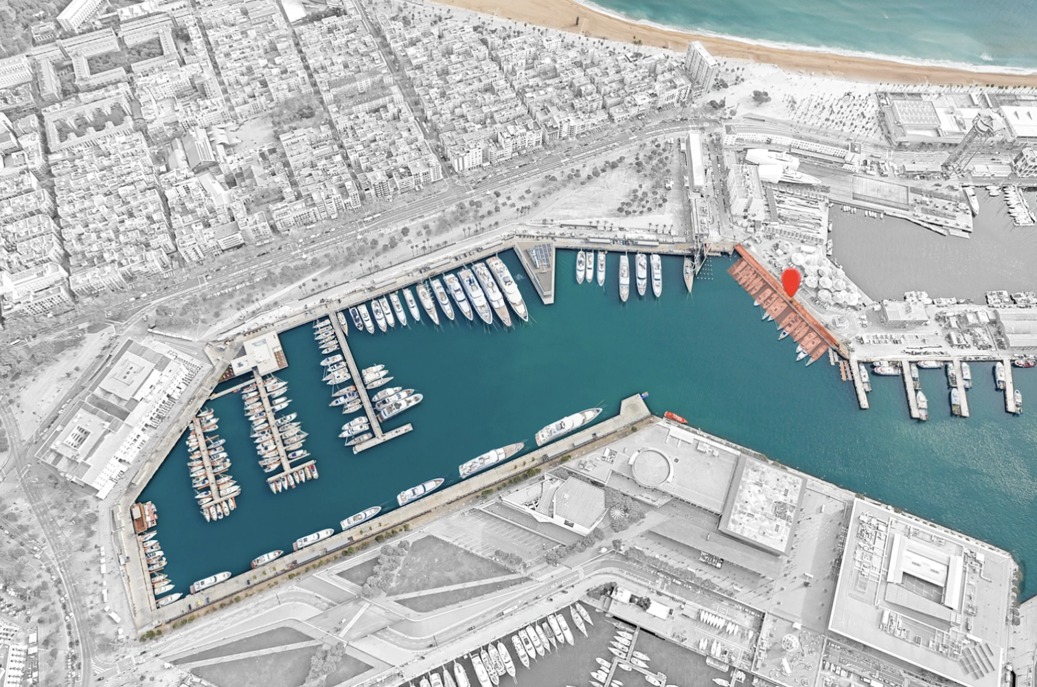 Aerial view of the MPV-Pescadors area in a marina with docks, yachts, and nearby urban buildings.