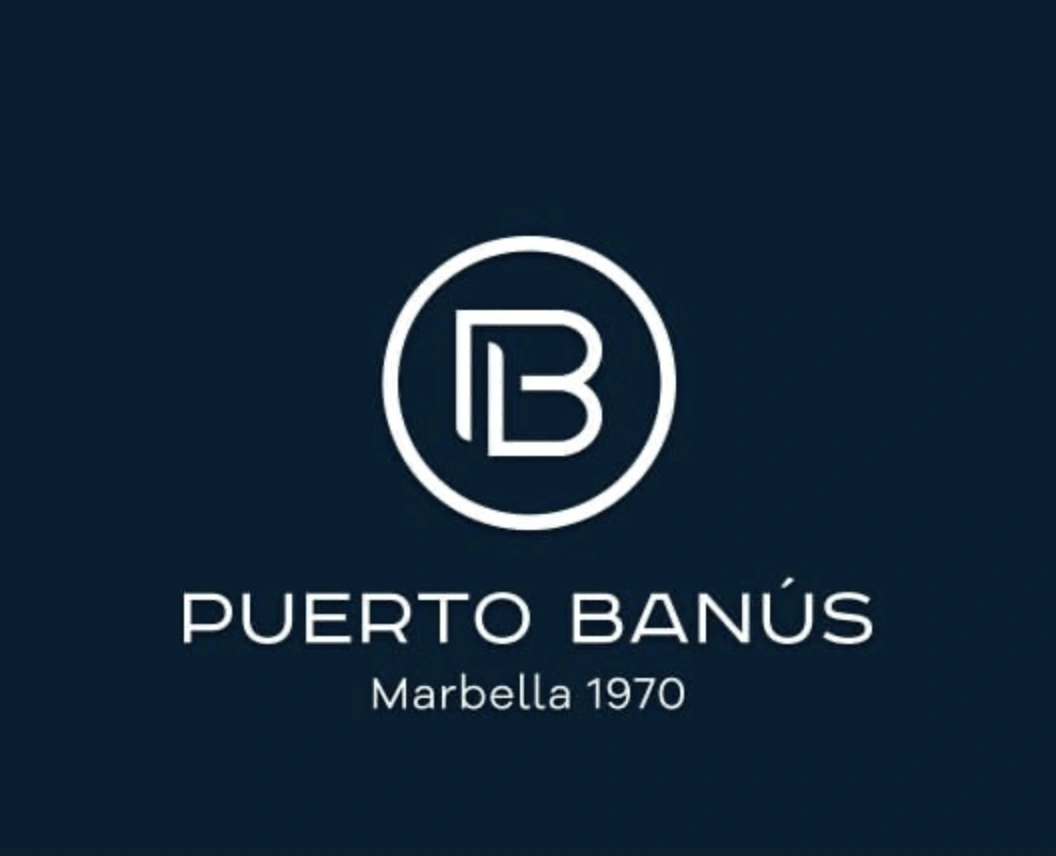 Logo of Puerto Banús with initials "PB" inside a circle and the text "Marbella 1970" below.