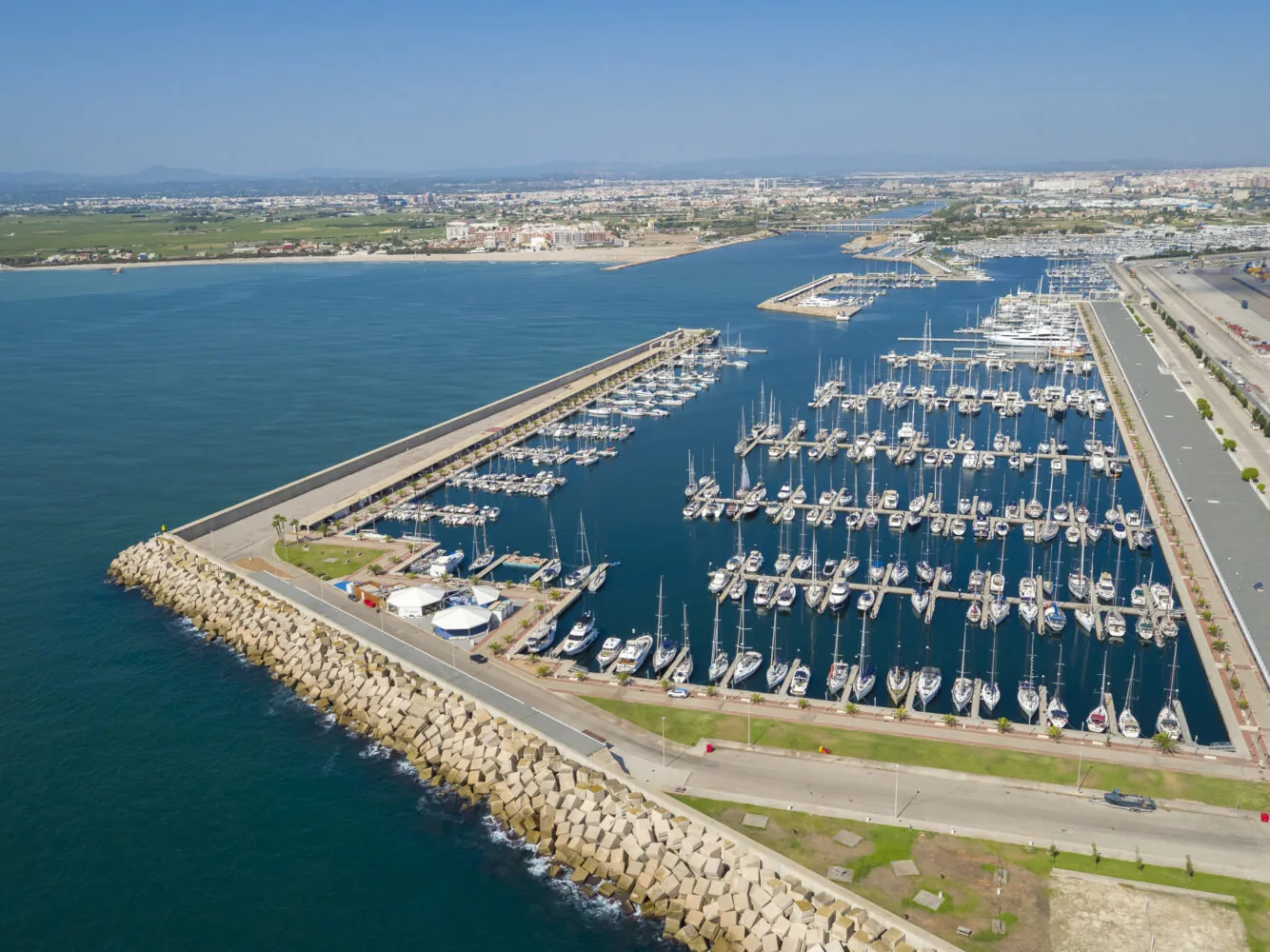 Aerial view of Marina de Valencia filled with numerous docked sailboats and yachts.