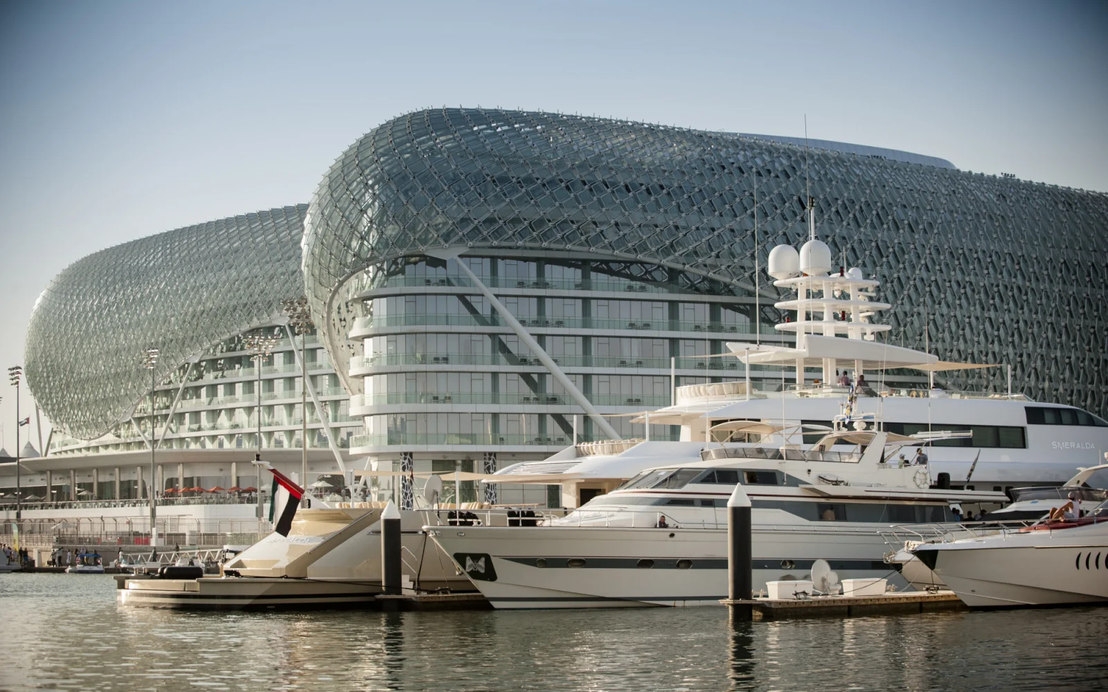 Luxury yachts docked in front of the futuristic Yas Hotel on Yas Island, Abu Dhabi.