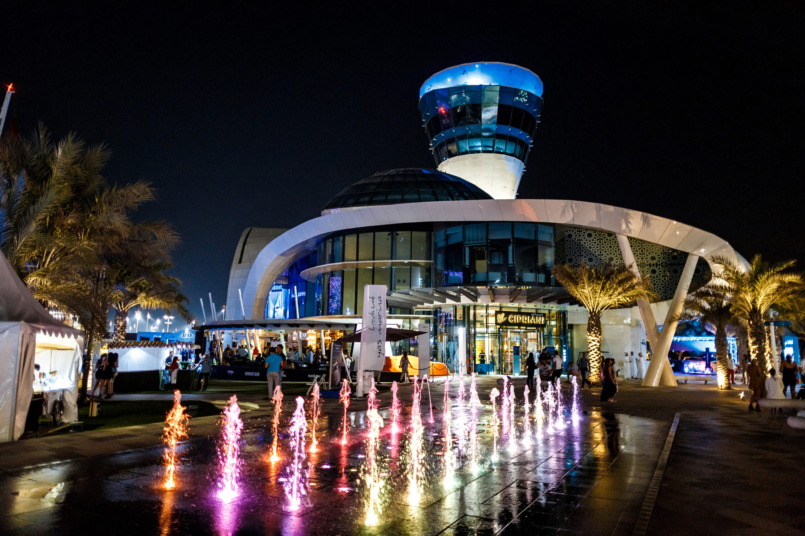 Colorful fountains light up the night in front of the futuristic Cipriani building at Yas Marina.