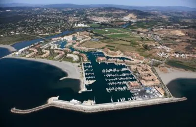 Aerial view of Puerto Sotogrande, showcasing the marina with numerous boats docked and surrounding residential areas.