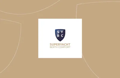 Logo of "Superyacht Berth Comfort" featuring a shield with the initials "SYBC" on a beige background.